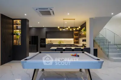 Luxurious modern living room with pool table and stylish kitchen, perfect for entertainment and relaxation.