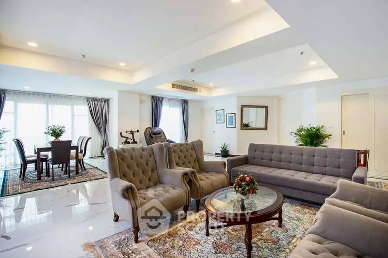 Spacious living room with elegant furniture and dining area, perfect for modern living.
