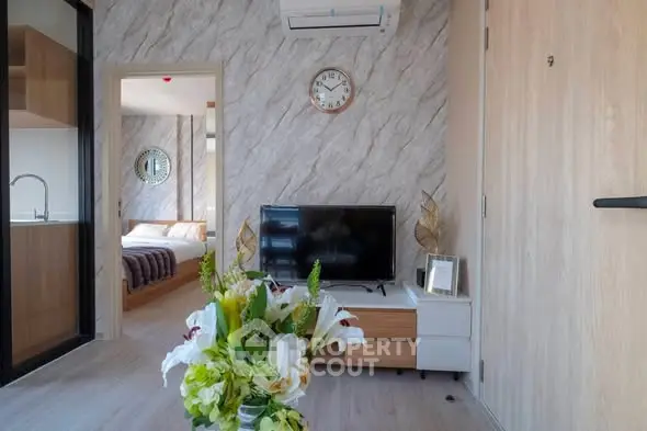 Modern living room with stylish decor and open view to bedroom