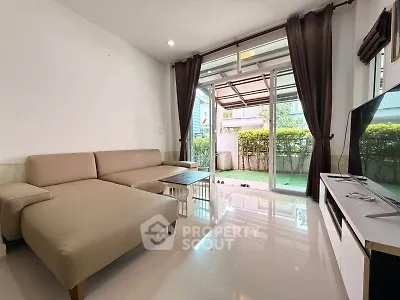 Spacious living room with modern furniture and garden view, perfect for relaxation and entertainment.