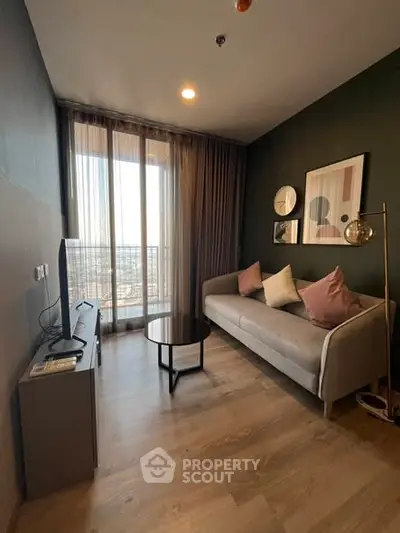 Stylish living room with modern decor and large window offering city view.