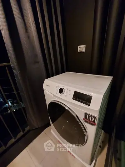 Modern washing machine on a balcony with city view, perfect for urban living.