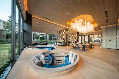 Luxurious modern living room with unique sunken seating and elegant chandelier, offering a spacious and stylish ambiance.
