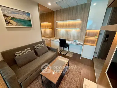 Modern living room with stylish decor and built-in study area, featuring cozy sofa and elegant lighting.