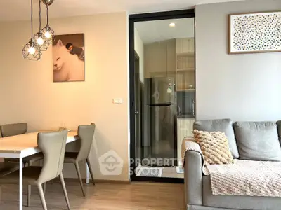 Modern living room with dining area and cozy decor in stylish apartment.