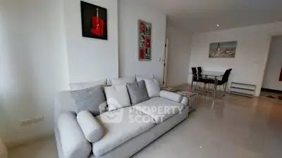 Modern living room with stylish gray sofa and contemporary art decor.
