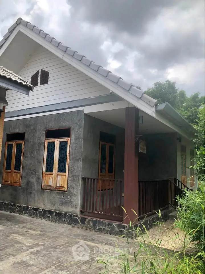 Charming rustic house with wooden accents and lush greenery, perfect for serene living.