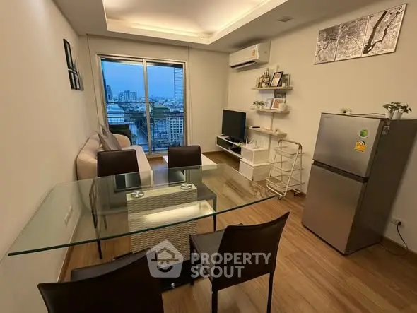 Modern living room with city view, glass dining table, and sleek decor.