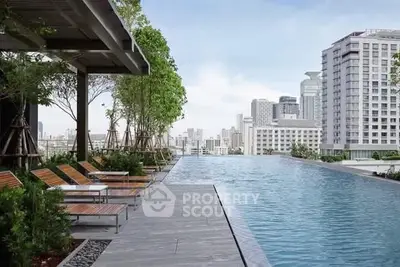 Luxurious rooftop pool with city skyline view and modern lounge chairs.
