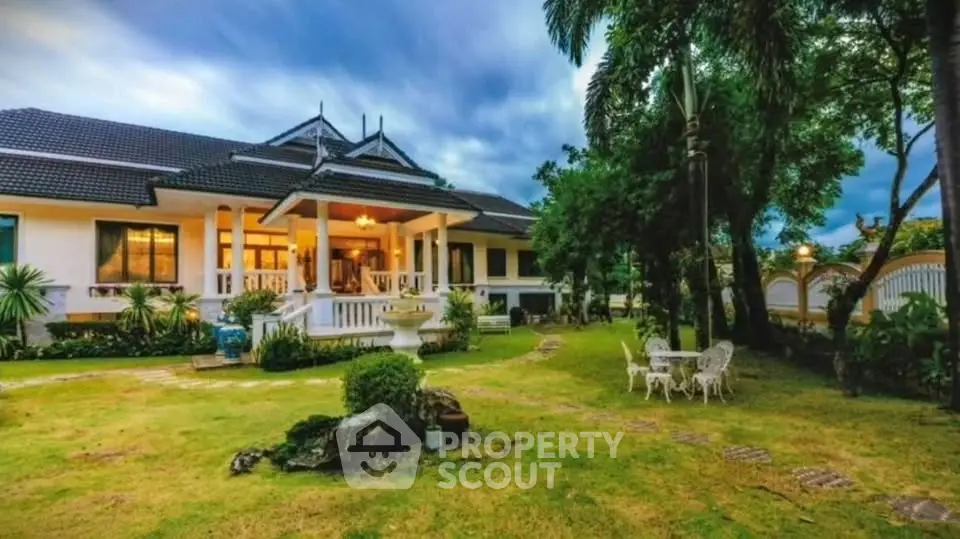 Luxurious villa with lush garden and elegant outdoor seating area