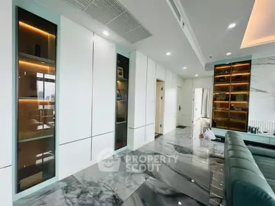 Luxurious modern living room with sleek marble flooring and elegant built-in cabinets.