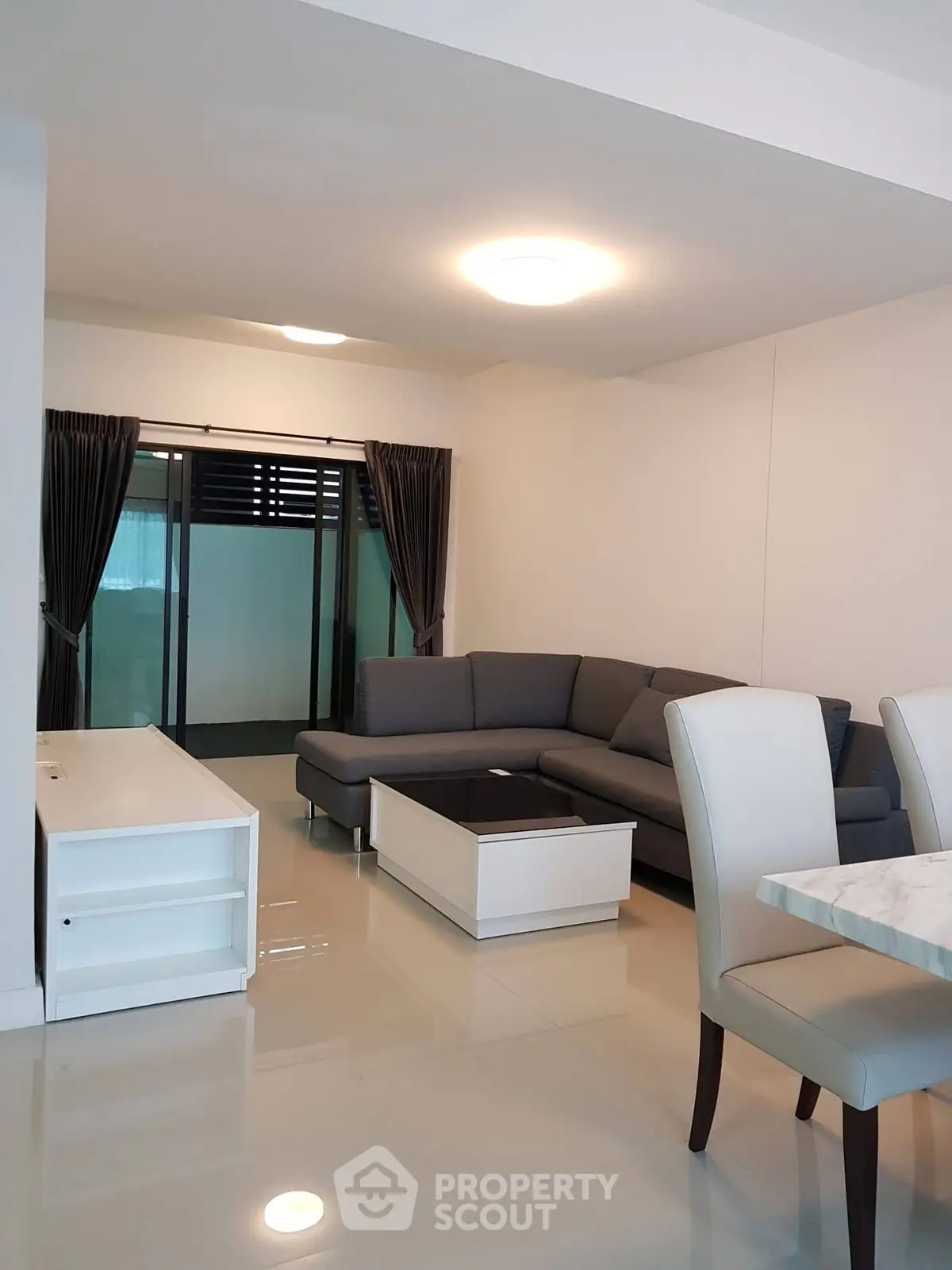 Modern living room with sleek furniture and elegant lighting in a stylish apartment.
