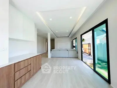 Spacious modern living room with large windows and sleek design