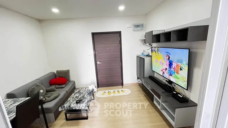 Modern living room with sleek furniture and wall-mounted TV