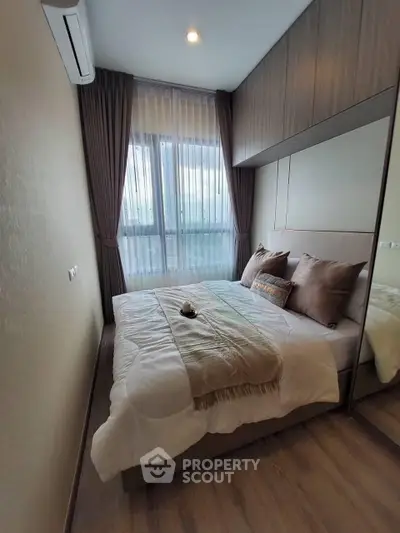 Cozy bedroom with modern design, featuring large window and elegant curtains, perfect for relaxation.