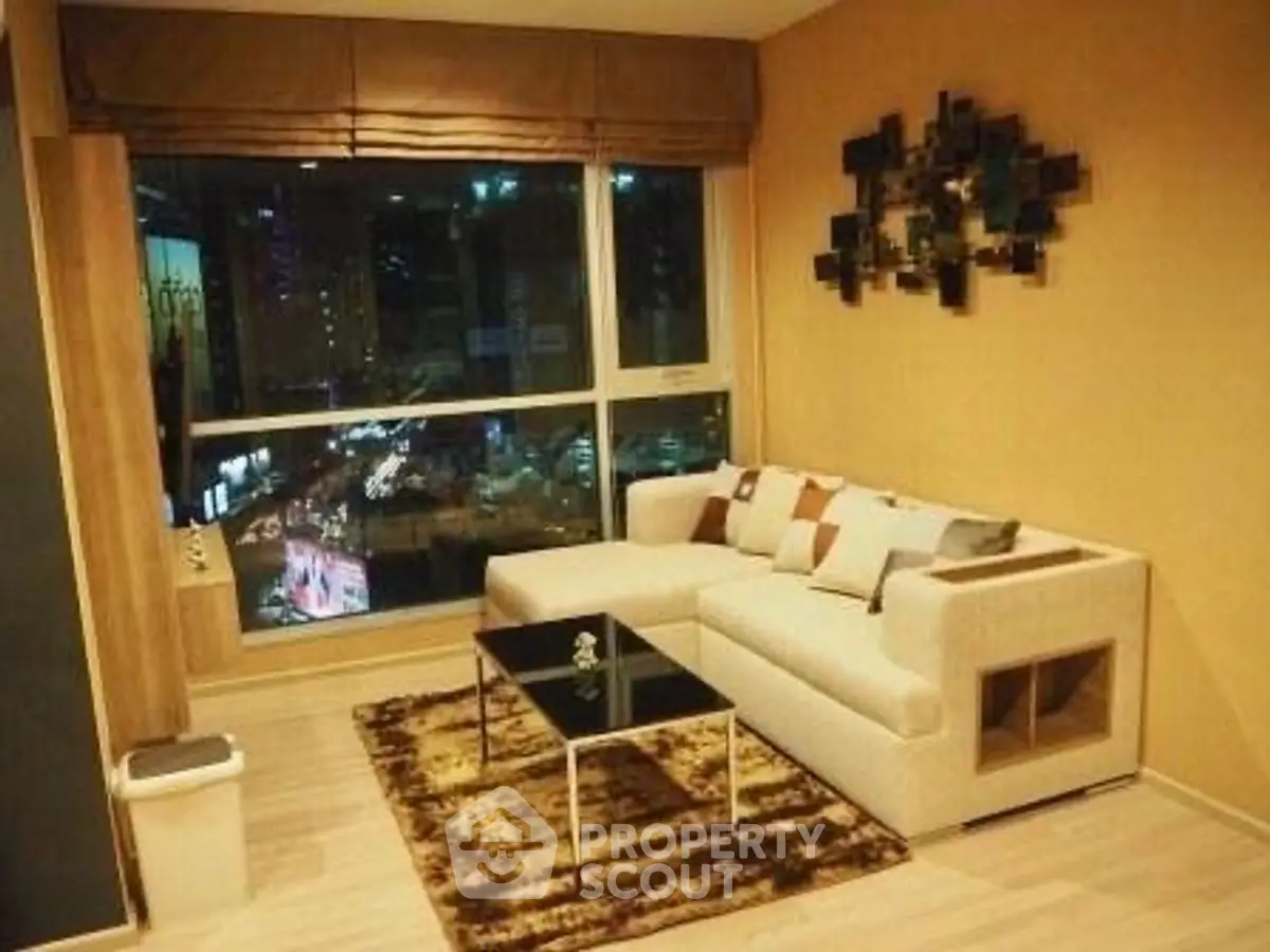 Chic modern living room with city view, stylish sofa, and elegant decor.