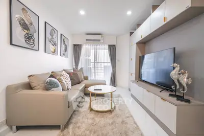 Elegant living room with modern furnishings, neutral color palette, and tasteful wall art creating a welcoming atmosphere, perfect for relaxation or entertaining guests.