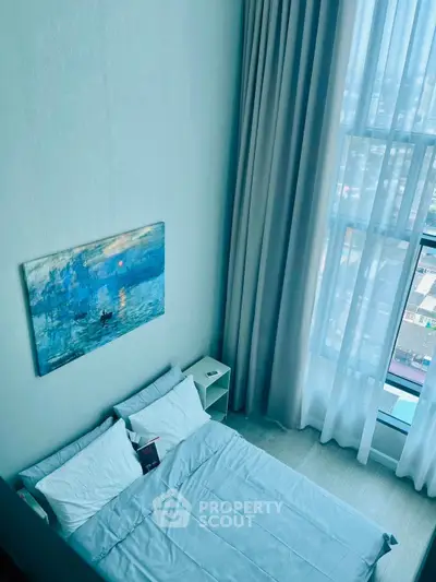 Modern bedroom with high ceiling and large window offering city view