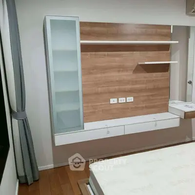 Modern bedroom with built-in wooden shelves and cozy ambiance