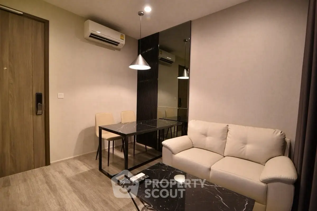 Modern living room with sleek furniture and stylish lighting in a contemporary apartment.