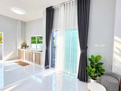 Bright and spacious living room with large windows and modern decor