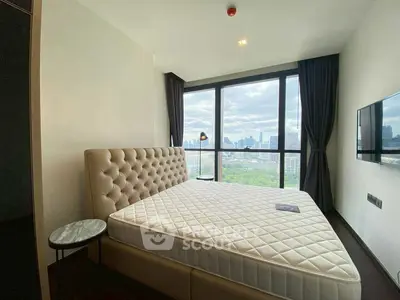Luxurious bedroom with stunning city view and modern furnishings.