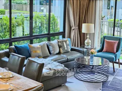 Luxurious living room with modern decor and large windows overlooking greenery.