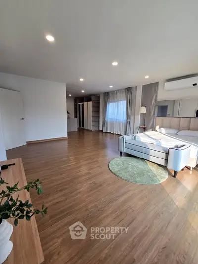 Spacious modern bedroom with elegant decor and natural light