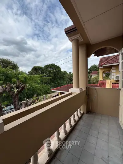 Charming balcony with scenic view in suburban home, perfect for relaxation and enjoying nature.