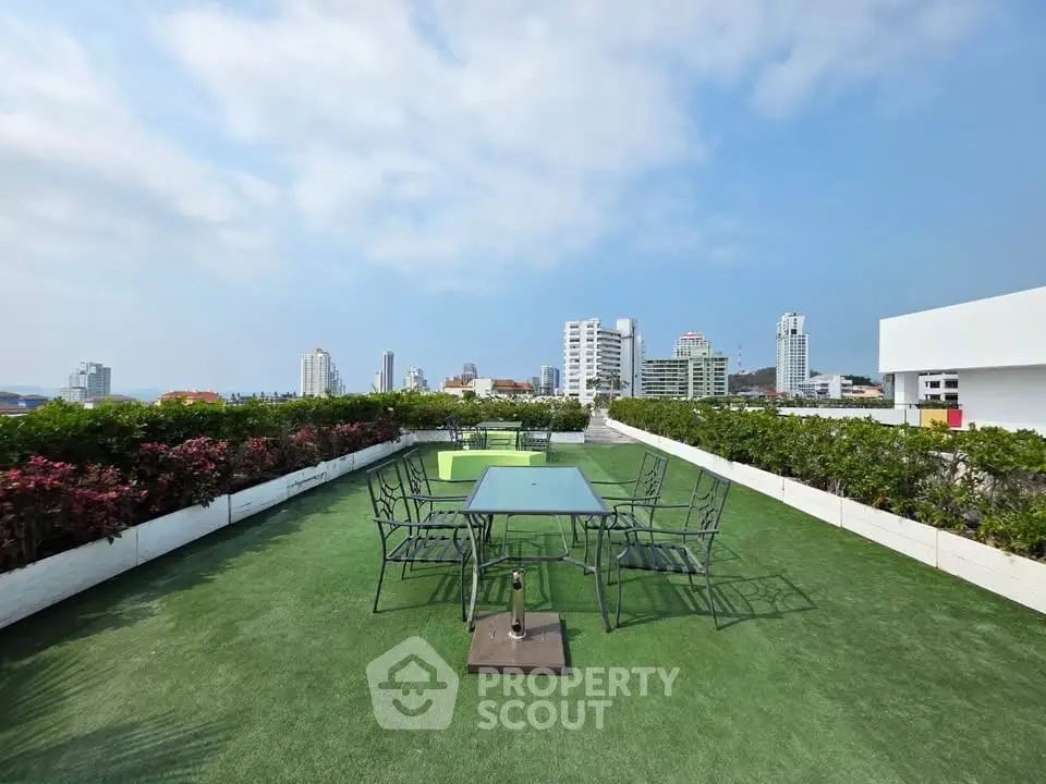 Stunning rooftop garden with city skyline views and modern outdoor seating.