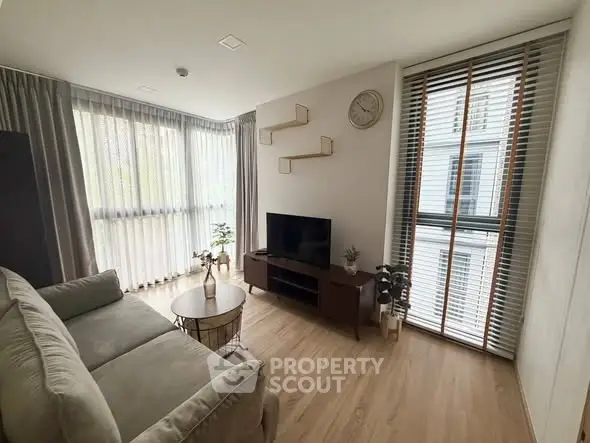 Modern living room with stylish decor and large windows in a contemporary apartment.