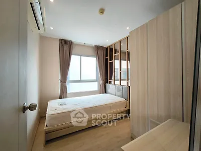 Modern bedroom with large window and stylish wooden accents.