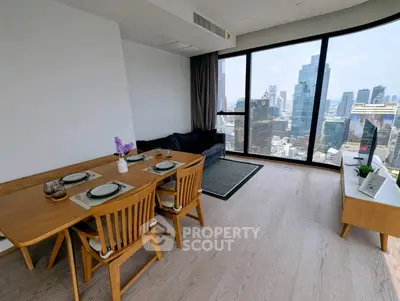 Modern living room with city view, featuring elegant dining set and cozy seating area.