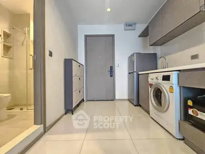 Modern apartment entrance with washing machine and sleek storage solutions
