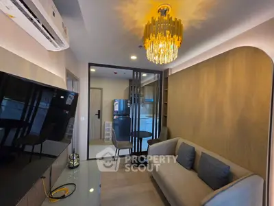 Modern living room with elegant chandelier and cozy sofa in stylish apartment