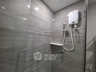 Modern bathroom with sleek shower and elegant gray tiles