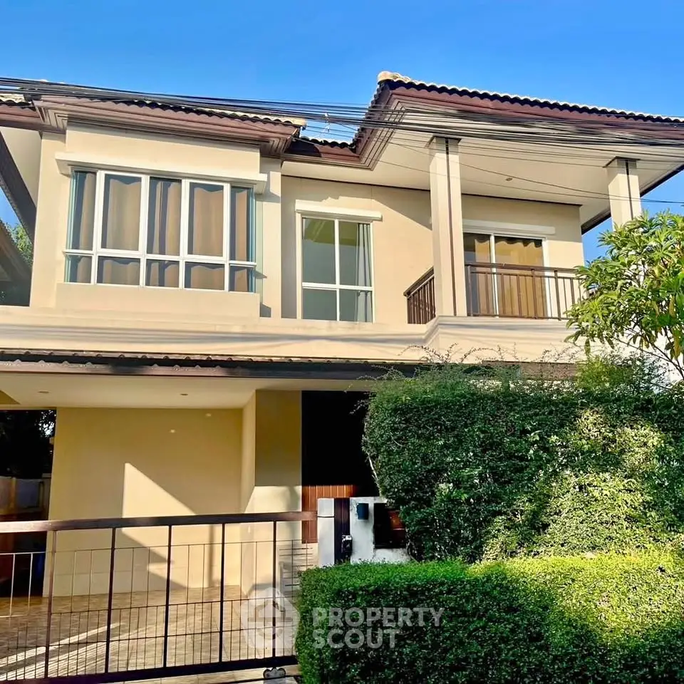 Charming two-story house with lush greenery and modern architecture, perfect for family living.