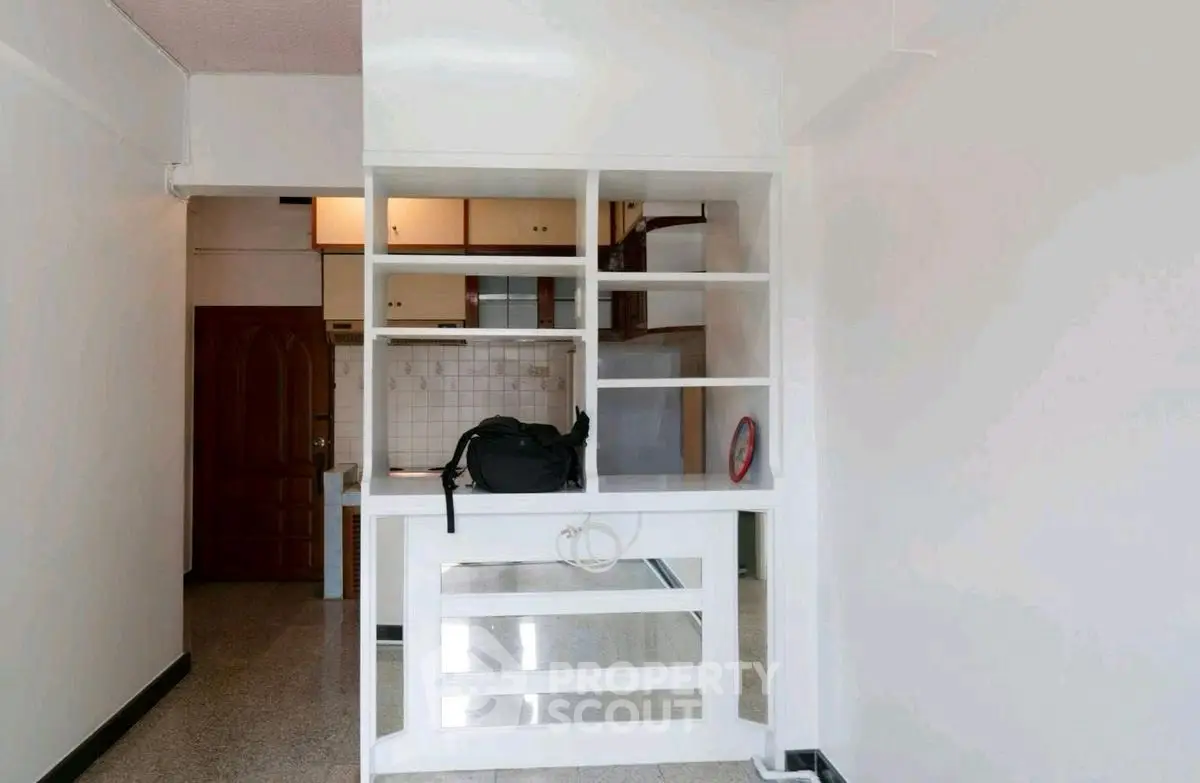 Spacious apartment interior with open kitchen layout and ample storage space.