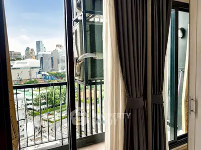 Modern city view from a stylish apartment balcony with elegant curtains and urban skyline.