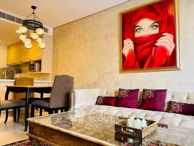 Elegant living room with modern decor and striking artwork, featuring cozy seating and stylish lighting.