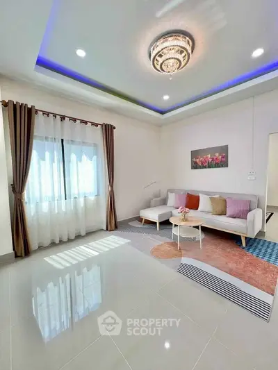 Elegant living room with modern chandelier and cozy seating area