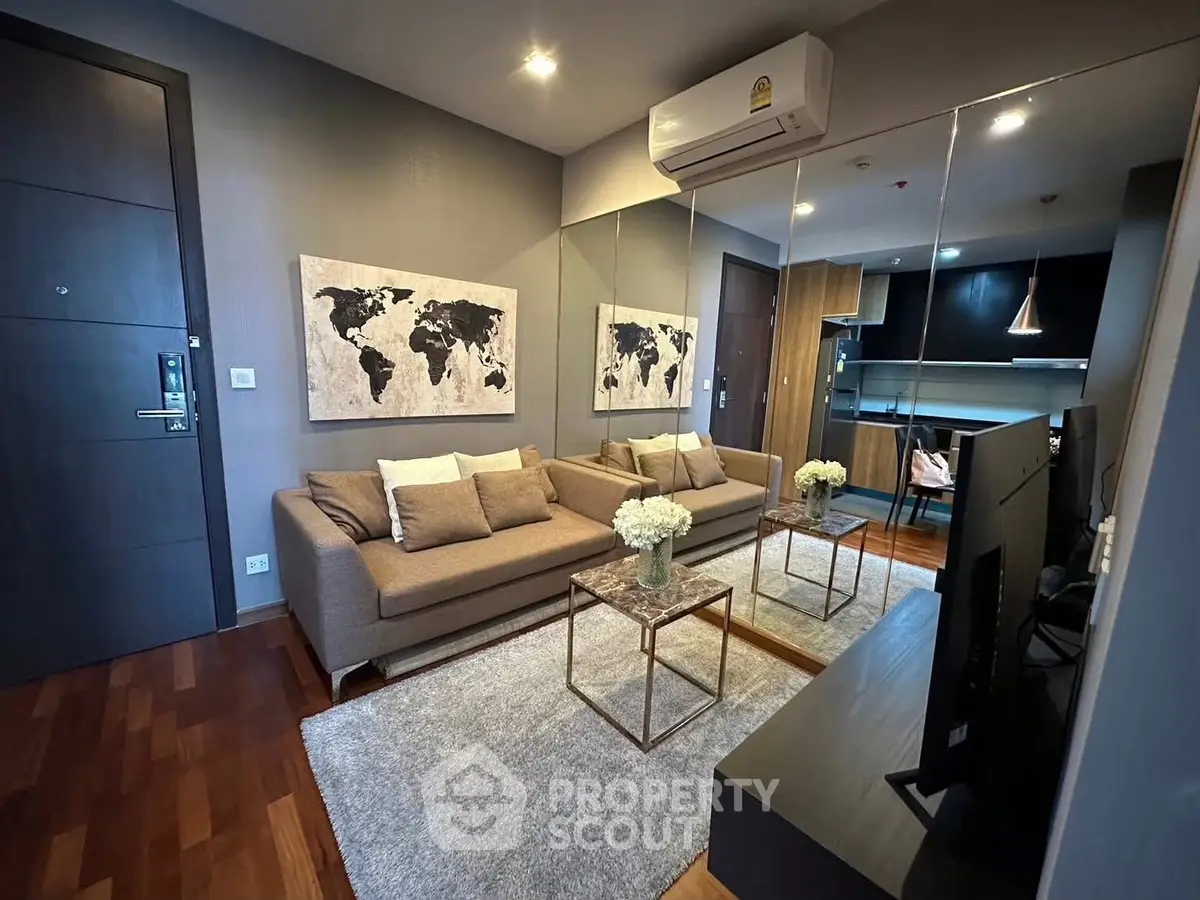 Modern living room with stylish decor and open kitchen layout in a cozy apartment.
