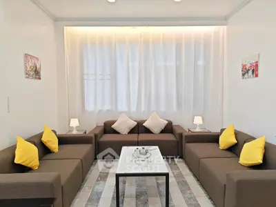 Stylish living room with modern sofas and bright yellow cushions, perfect for relaxation and entertaining.
