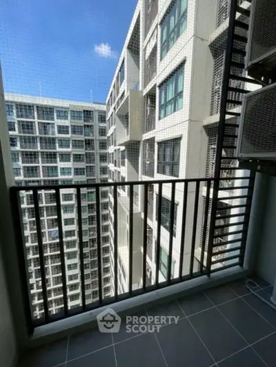 Modern apartment balcony with city view and safety netting