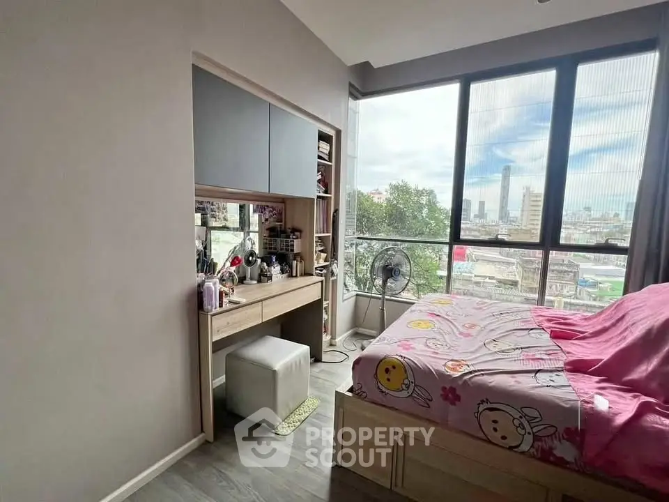 Charming bedroom with city view, featuring large windows and cozy decor, perfect for urban living.