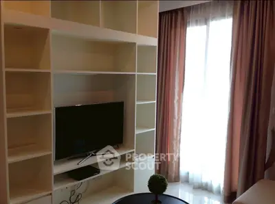 Modern living room with built-in shelves and large window for natural light.