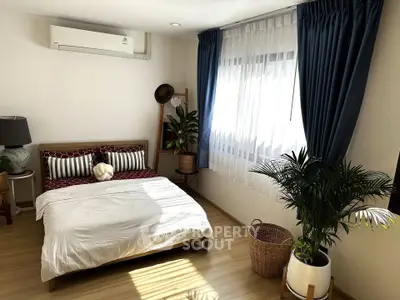 Charming bedroom with natural light, stylish decor, and cozy ambiance for a perfect retreat.