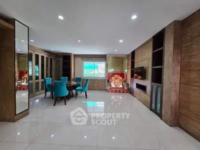 Spacious living room with modern decor and elegant dining area