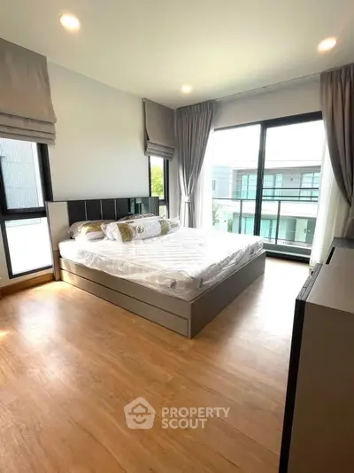 Spacious modern bedroom with large windows and elegant decor