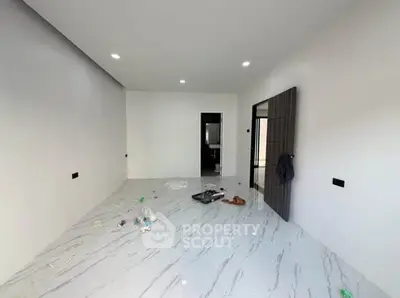 Spacious modern room with sleek marble flooring and recessed lighting, perfect for customization.